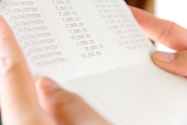 Person looking at financial numbers on spreadsheet