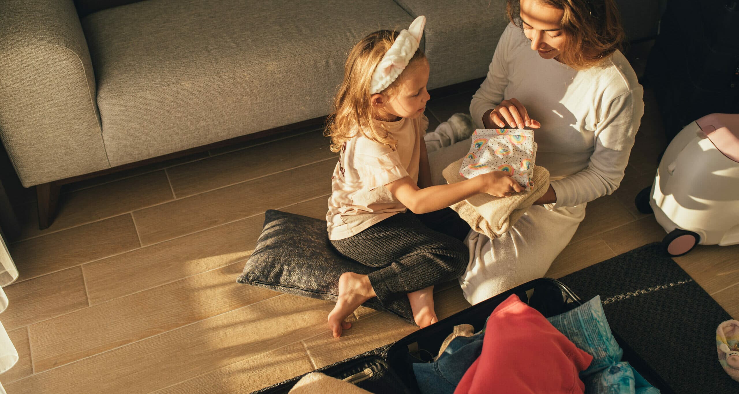 Mother and daughter packing clothes before a trip