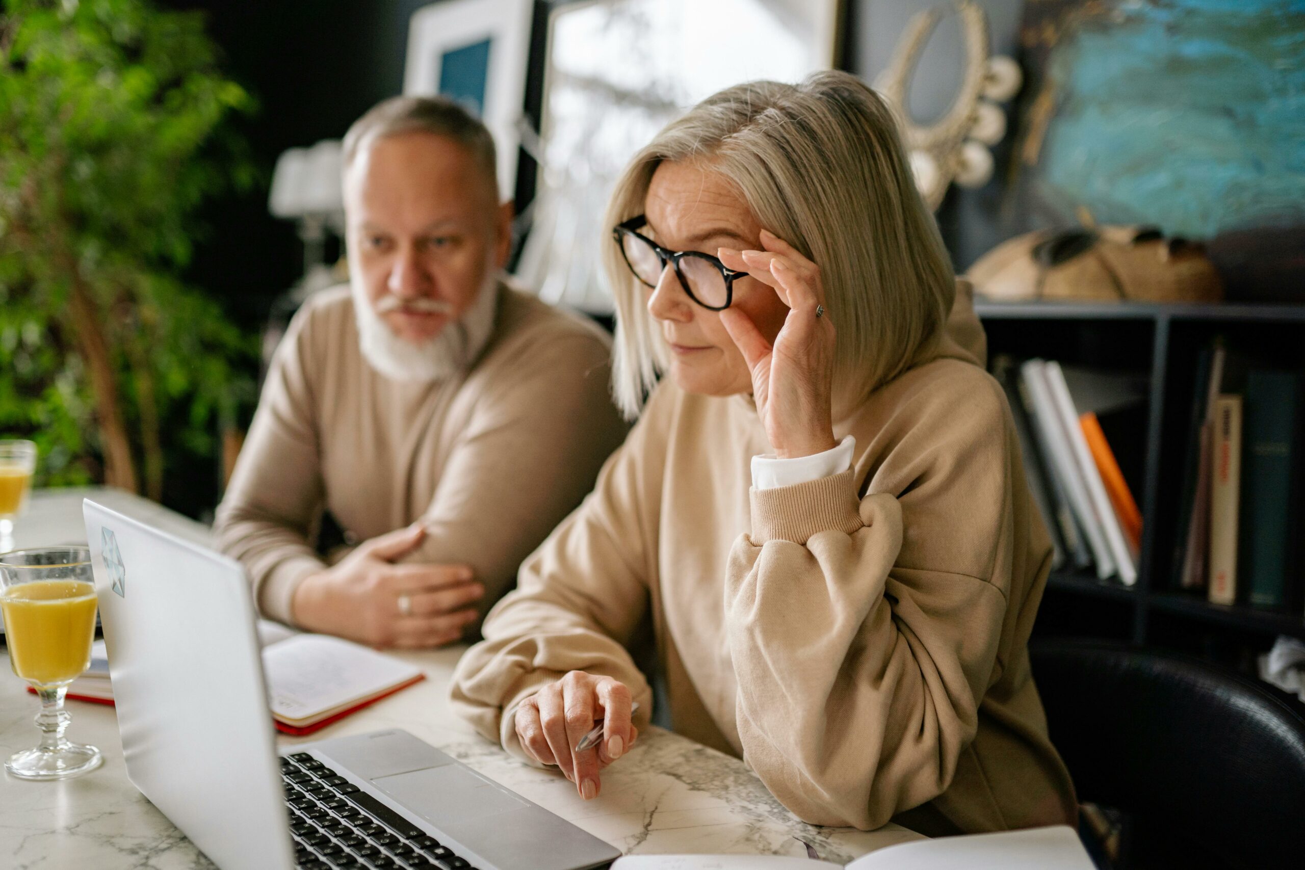 Older couple researching divorce options on laptop