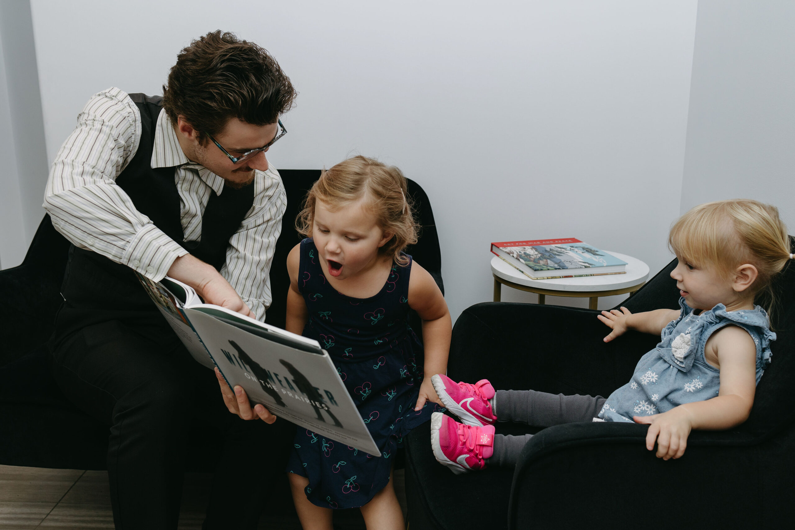 Lawyer reading with children, emphasizing child-friendly parenting arrangements in Saskatoon.