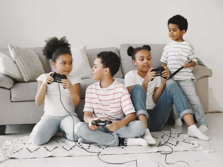Kids playing on game console in living room